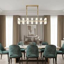 Lunara linear marble chandelier over a dining table