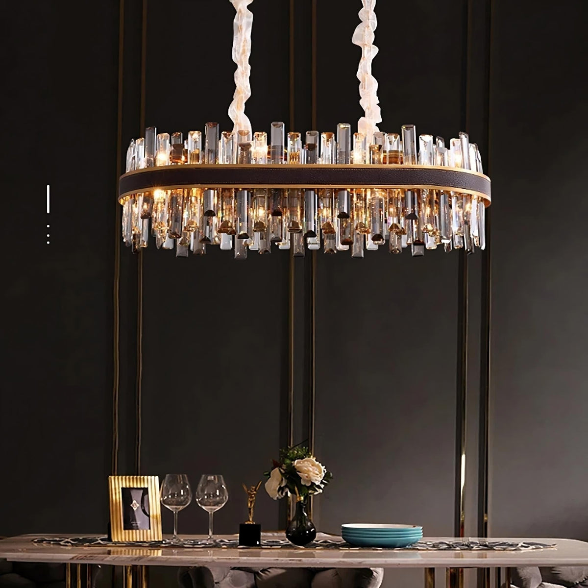 Calvi crystal dining chandelier on polished steel over a table Main image