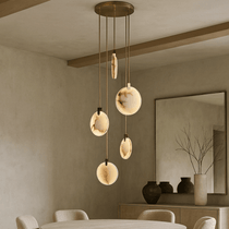 Moonshade 5-light marble chandelier illuminated over a dining table