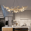 Albero gold branch crystal linear chandelier over a dining table