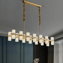 Lunara marble chandelier casting up and down light above an island