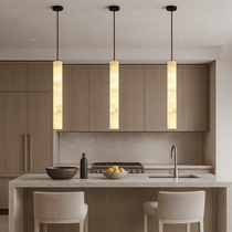 Moonshade slim natural marble pendant over a kitchen island