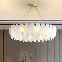 Foglia modern chandelier by Morsale.com, a 32-inch fixture of leaf-cut art glass on a polished stainless steel frame above a living room.