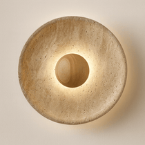 Oakley travertine wall sconce mounted on a wall