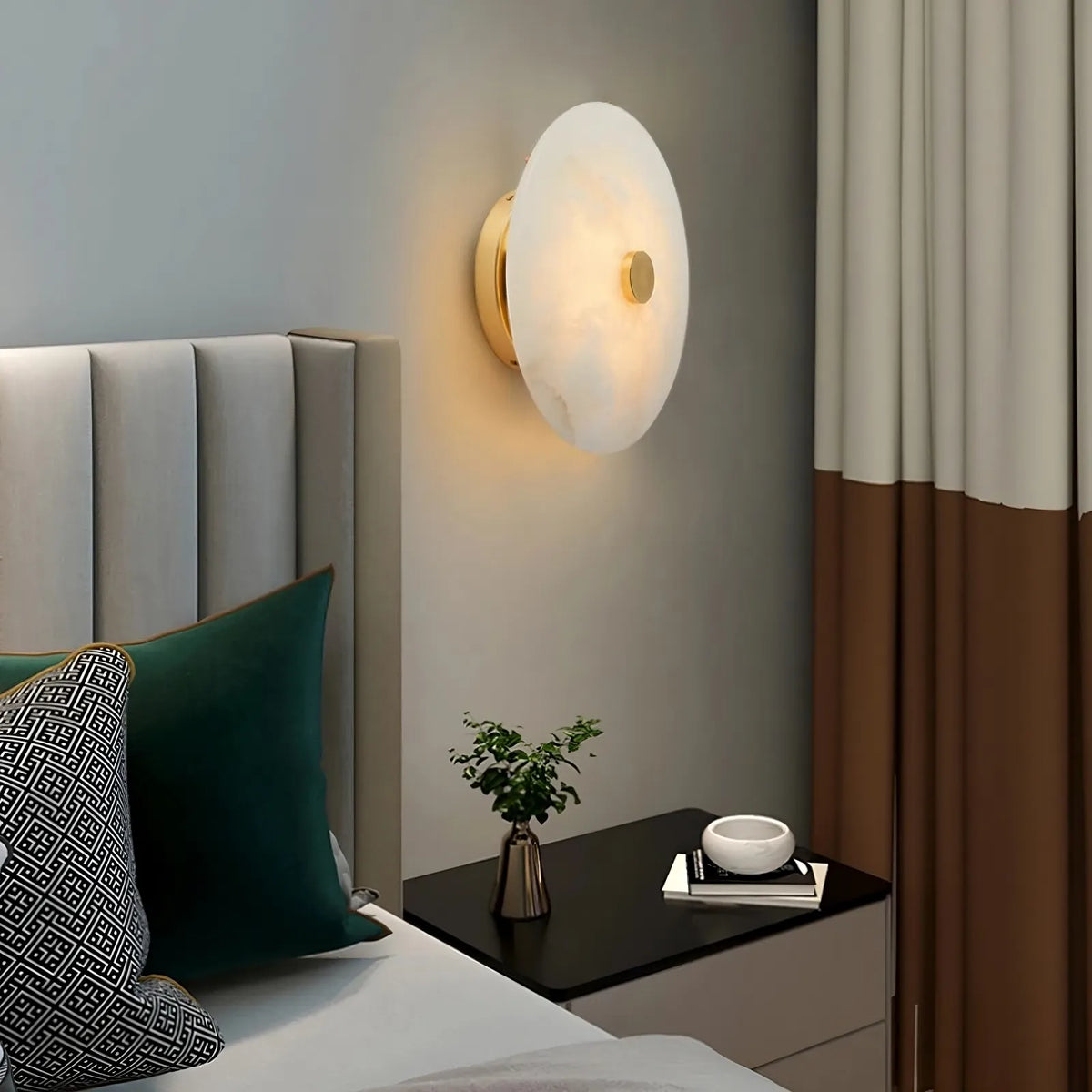 Witney marble and brass wall sconce mounted on a wall